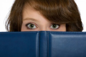 http://www.dreamstime.com/royalty-free-stock-images-beautiful-girl-hiding-behind-blue-open-book-image31692429