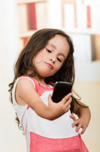 http://www.dreamstime.com/royalty-free-stock-image-cute-little-girl-using-cell-phone-taking-selfie-portrait-happy-image52775476